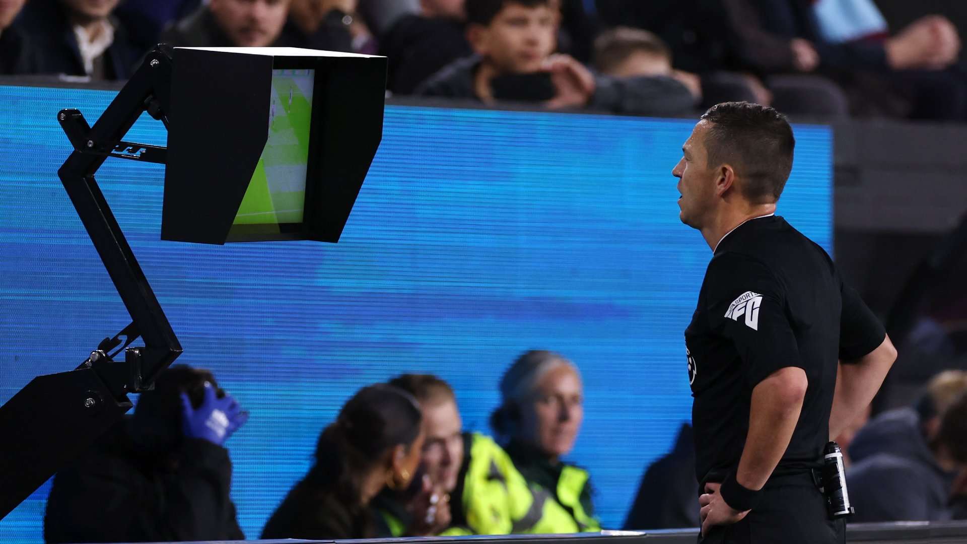 Referee Tony Harrington checks VAR Jonny Evans goal Burnley Man Utd 2023-24