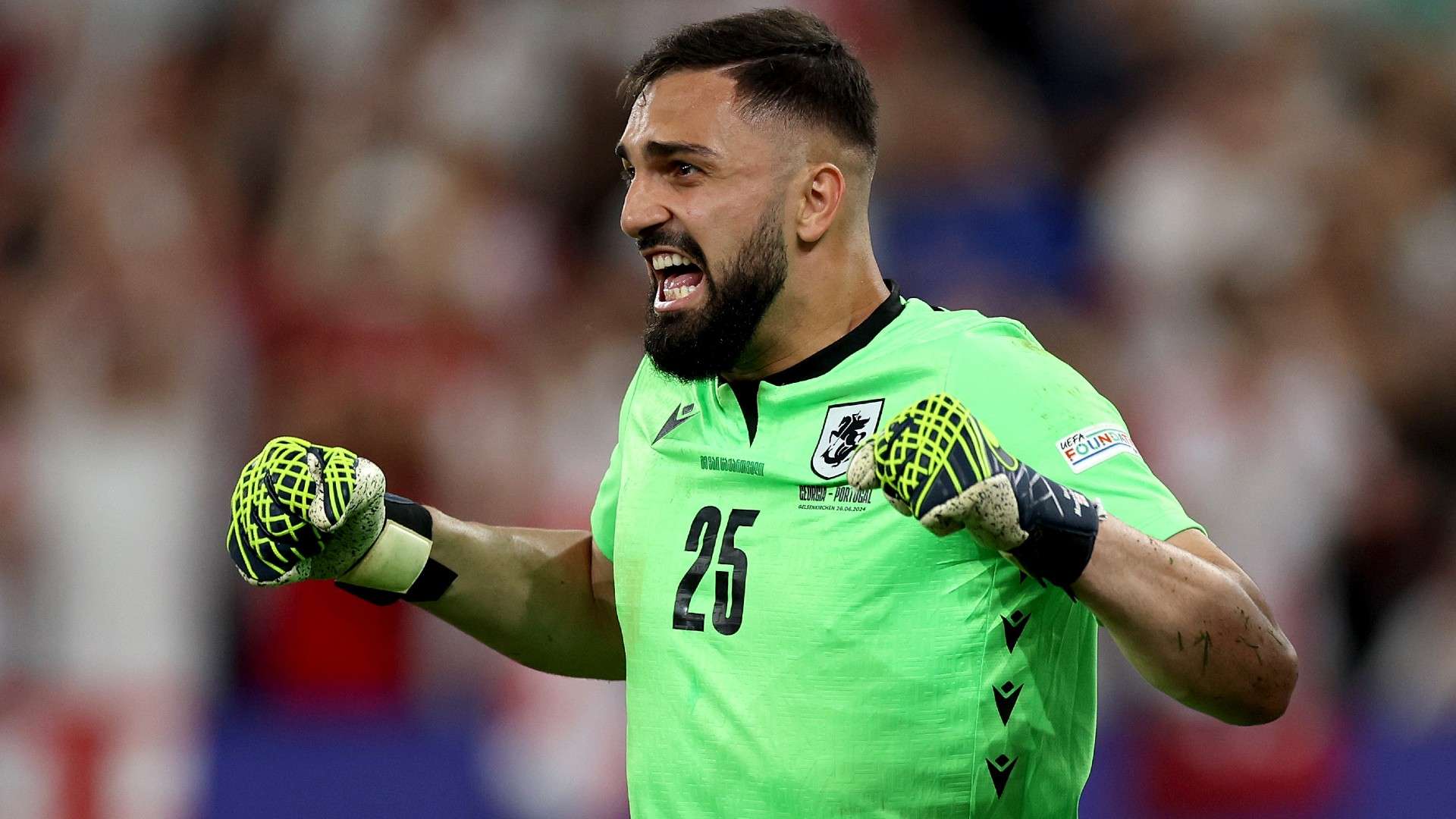 Giorgi Mamardashvili of Georgia celebrates after making a save